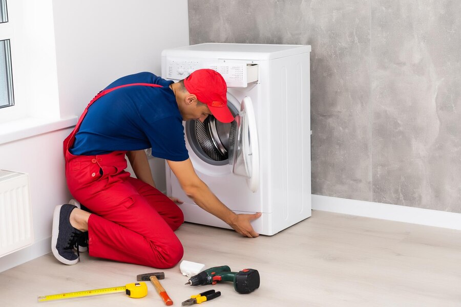 plumber-overalls-with-tools-is-repairing-washing-machine-house_493343-24474